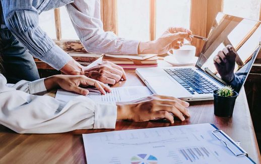 Duas pessoas analisando uma imagem em um laotop