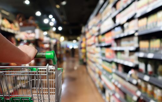 Mulher empurrando carrinho de compras no supermercado